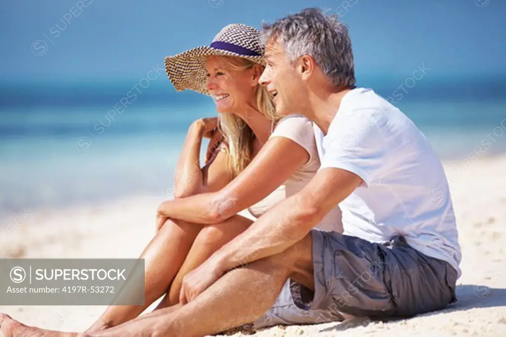 Portrait of mature couple relaxing together on beach