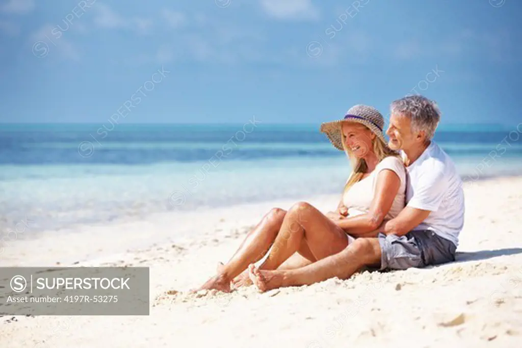 Full length of romantic mature couple spending time together on beach