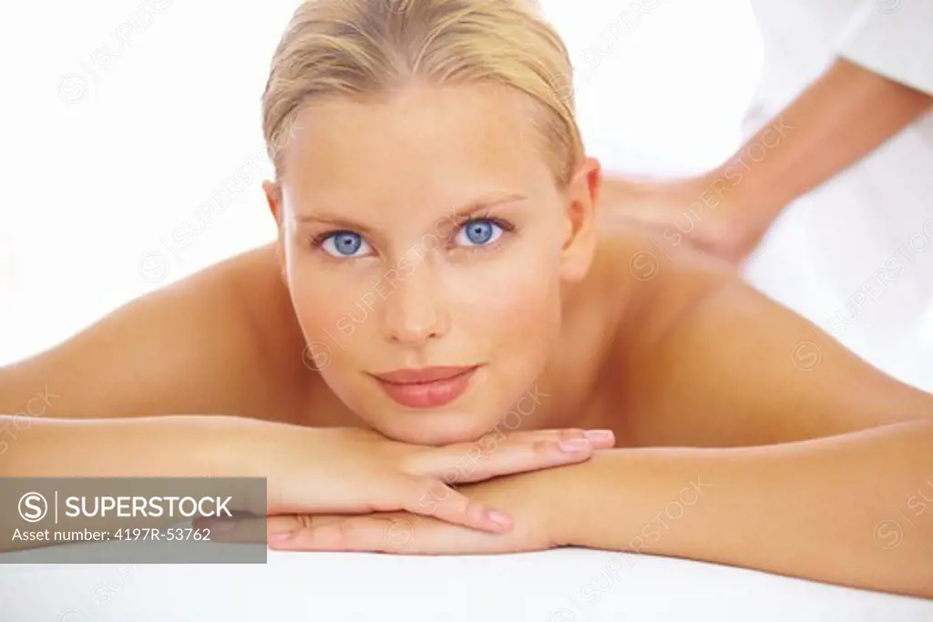 Pretty woman enjoying a back massage at the spa