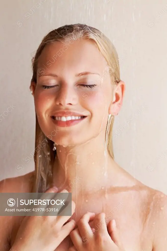 Happy smiling young woman having fresh shower