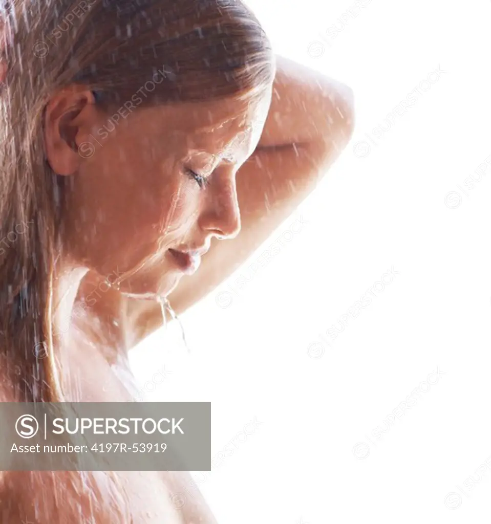 Closeup of cute young woman taking a relaxing bath under shower