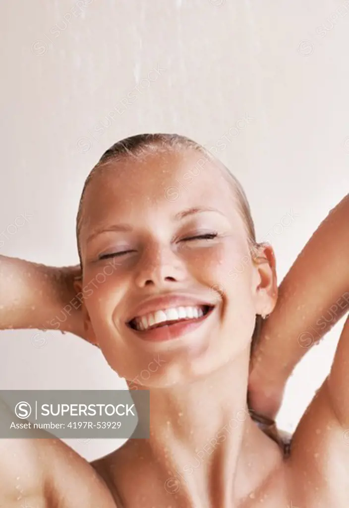 Pretty young woman enjoying bath under water shower
