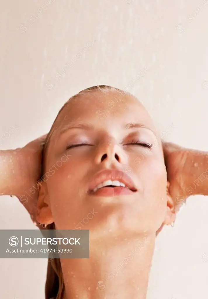Closeup of cute young woman face under shower