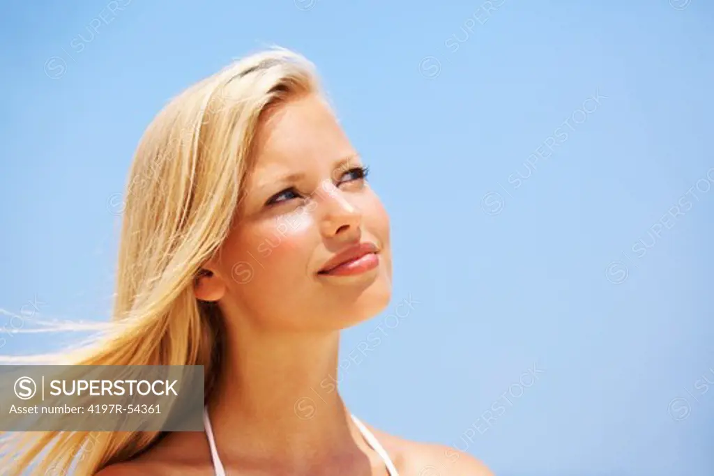 Closeup of relaxed young woman smiling outdoors