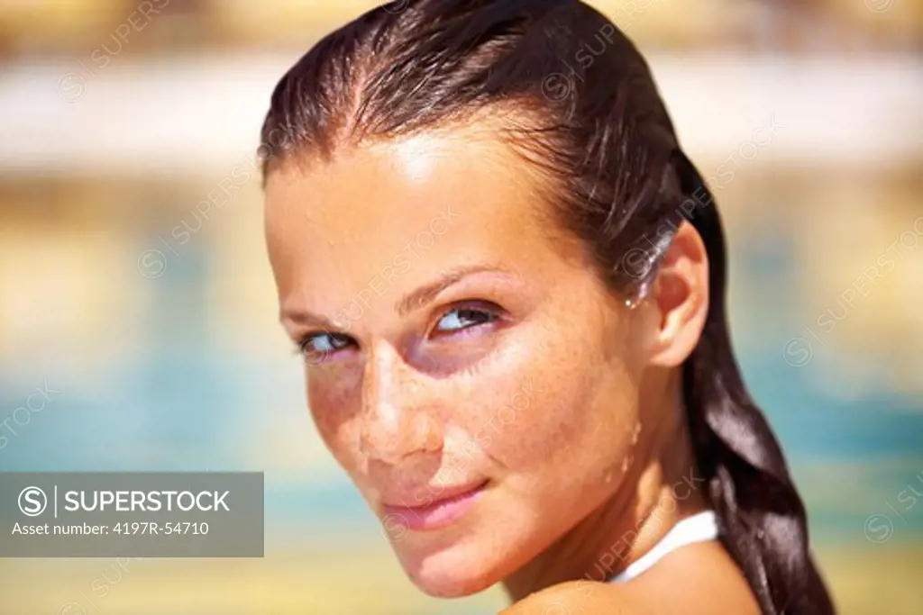 Beautiful woman in the resort pool looking sensual