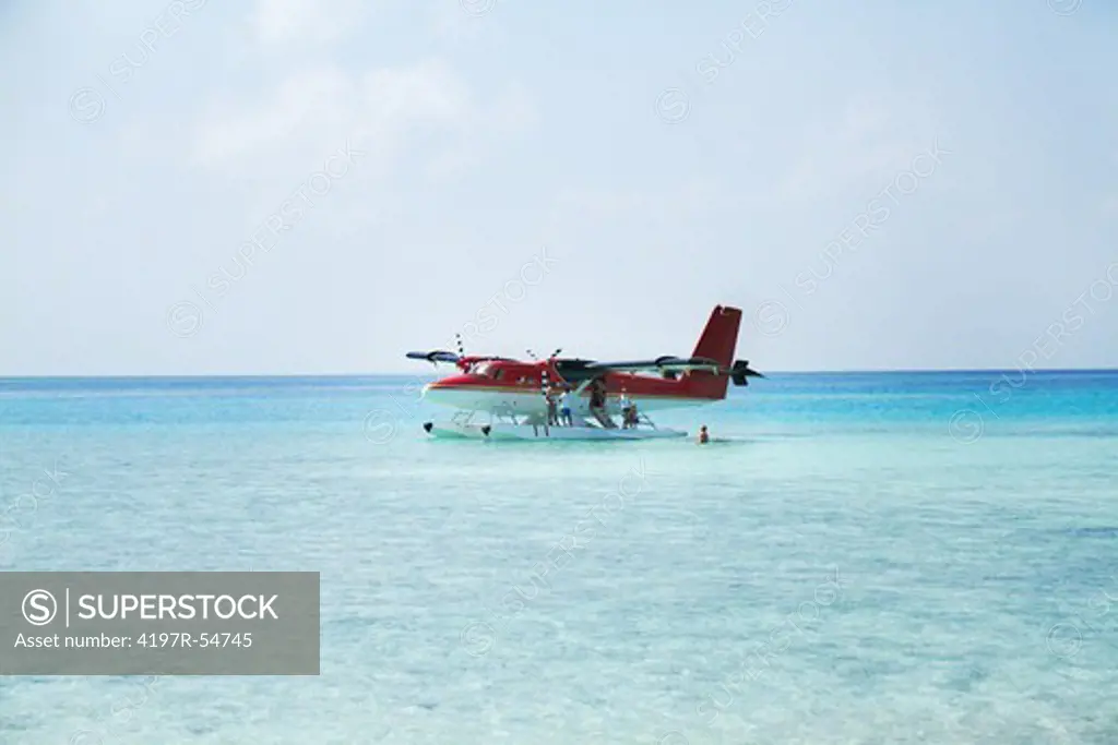 Private Jet that has landed on clear ocean water