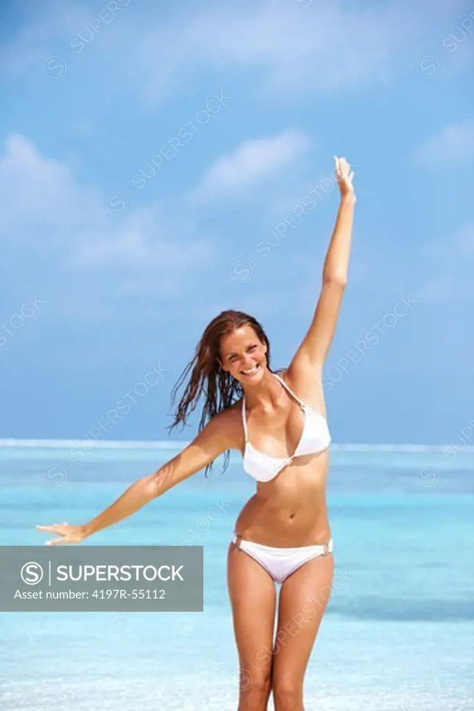 Portrait of playful young woman enjoying at beach