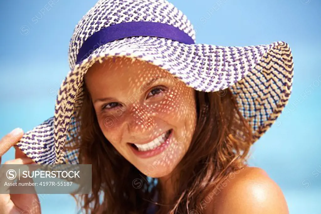 Closeup of gorgeous woman wearing sun hat outdoors