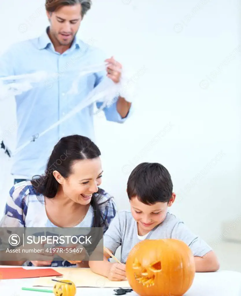 A young family making Halloween decorations together