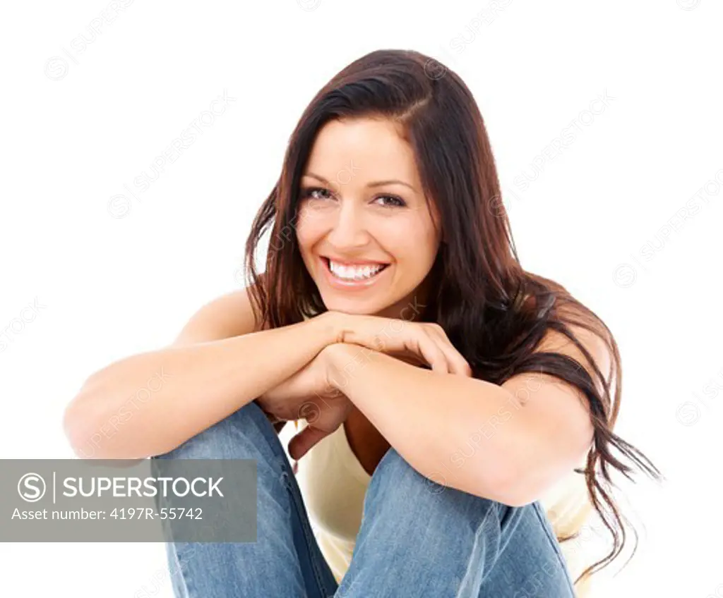 Portrait of a pretty young woman sitting in front of a white background
