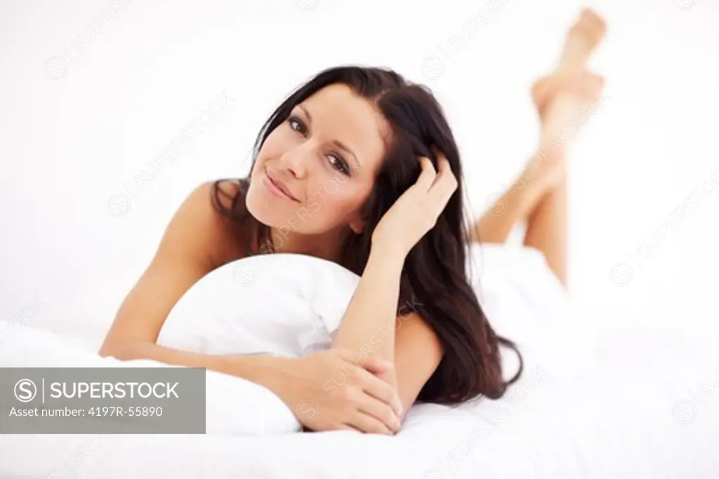 Portrait of a gorgeous young woman relaxing on her bed