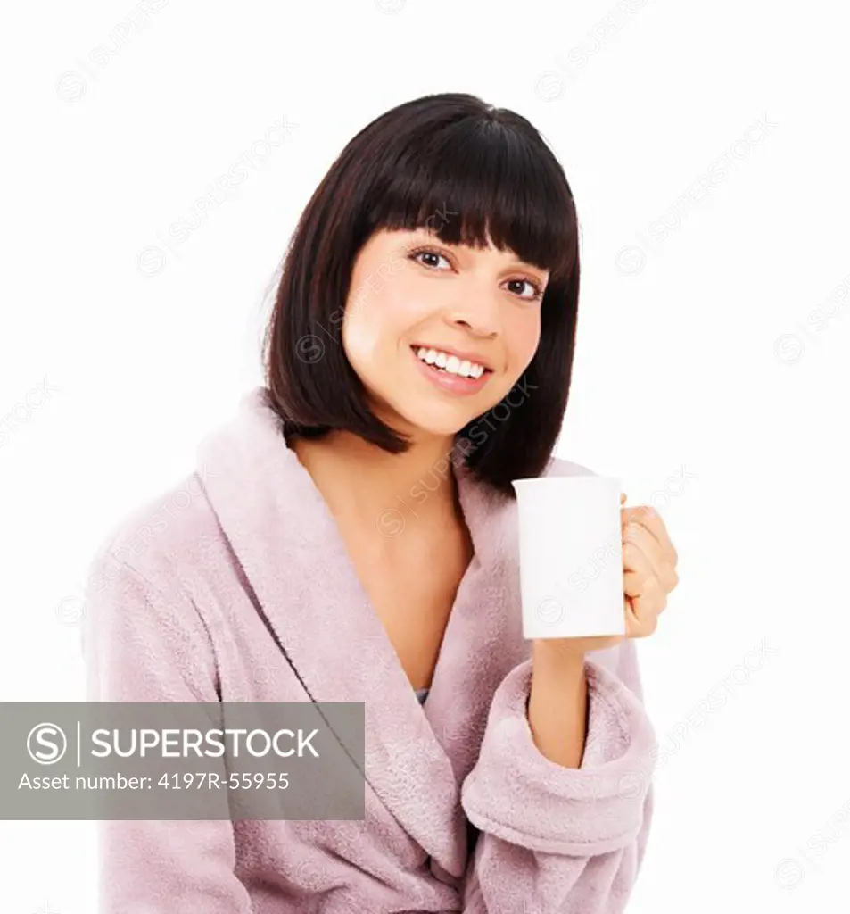 Cute young woman enjoying a fresh cup of coffee in her dressing gown