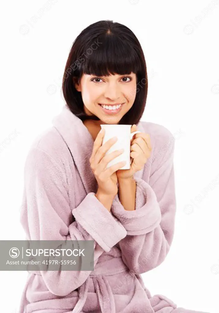 Cute young woman enjoying a fresh cup of coffee in her bathrobe