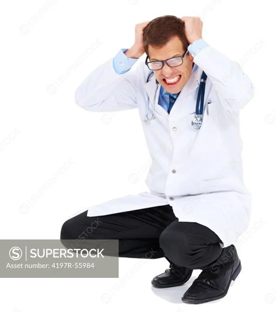 Portrait of a frustrated doctor pulling at his hair