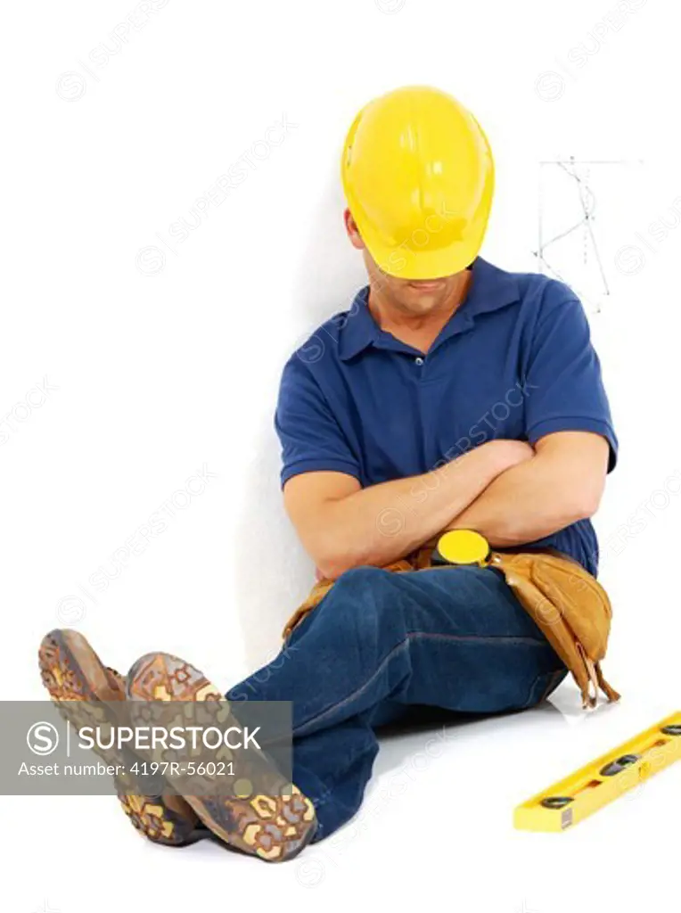 A young construction worker lying asleep on the job