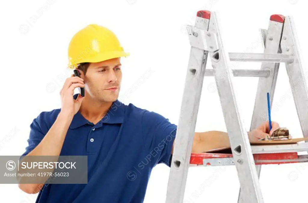 A young handyman talking on the phone while standing on a ladder