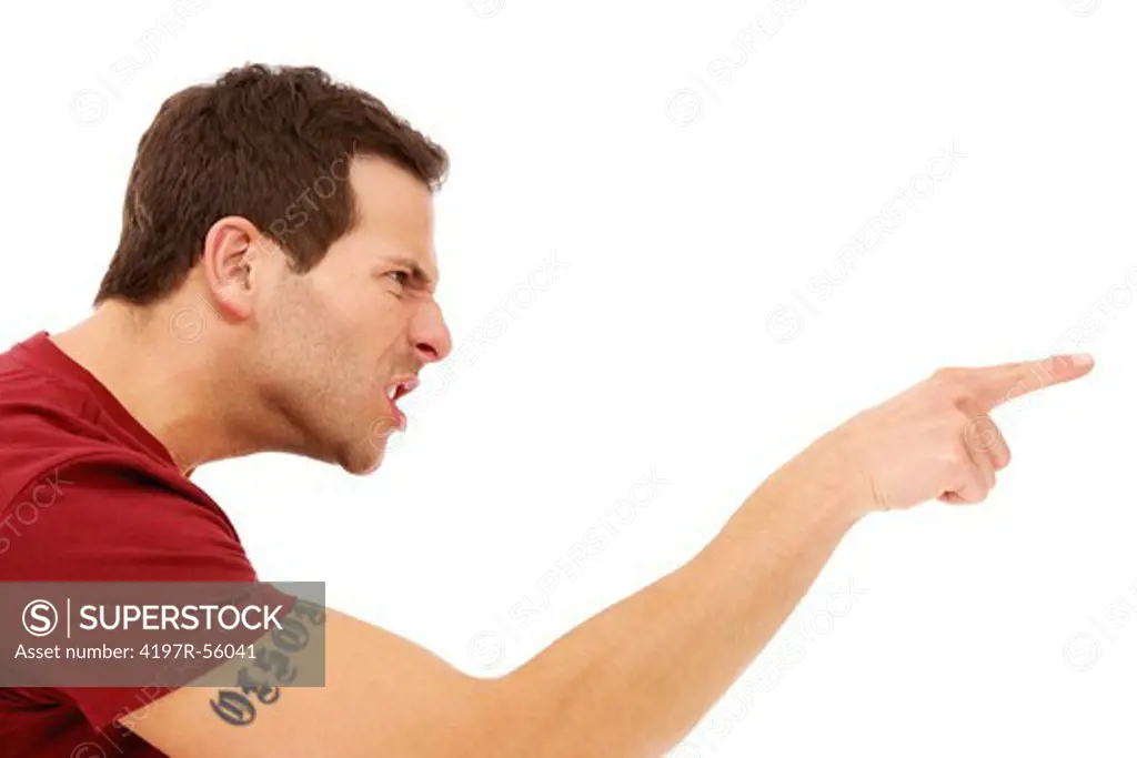 Profile of a young man pointing his finger at someone in anger