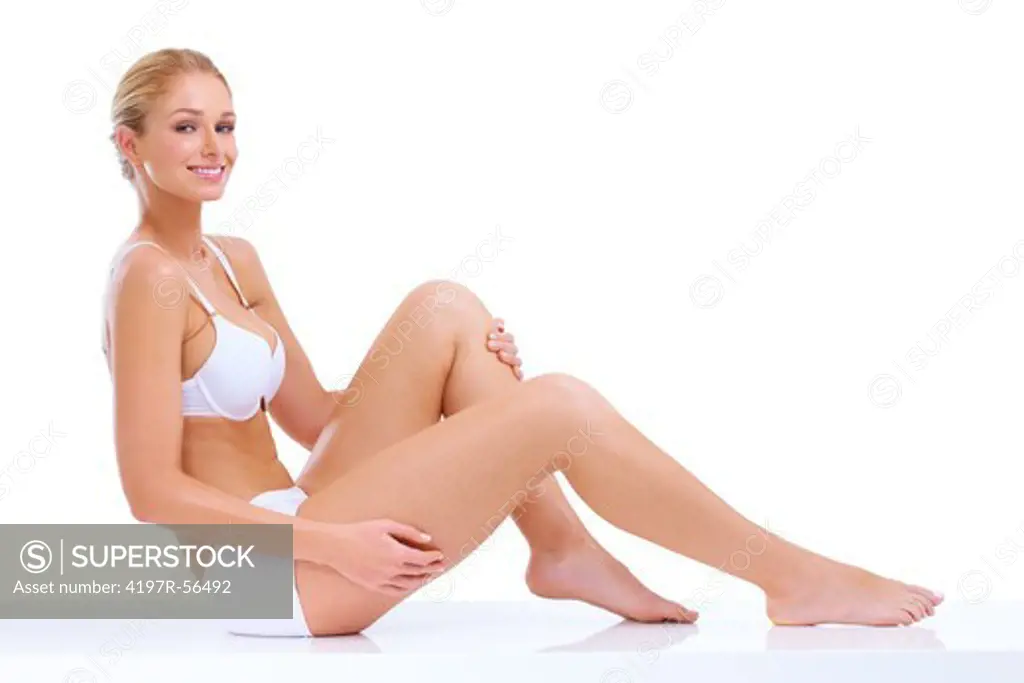 Beautiful happy young woman in white underwear smiling at camera