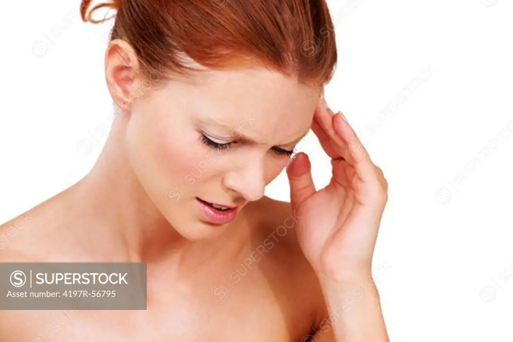 An attractive young woman touching her temple because of a headache isolated on white