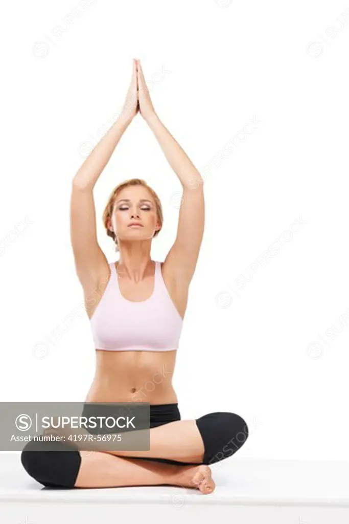 A beautiful woman performing the sitting tree during a yoga routine - Isolated