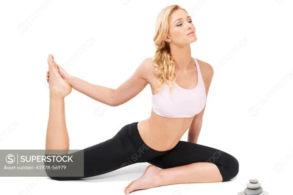 A beautiful woman performing the sitting bow pulling pose while isolated on white