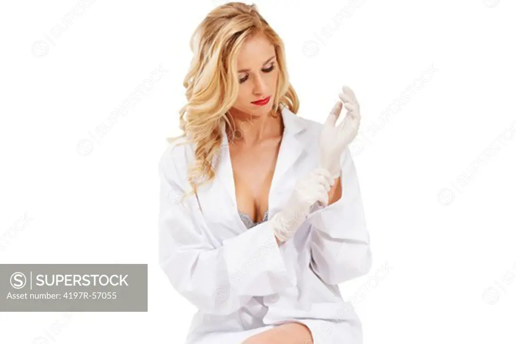 A sexy young doctor wearing a labcoat and lingerie pulling a surgical glove on