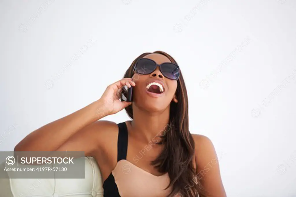Stylish African American woman on her cellphone while at home