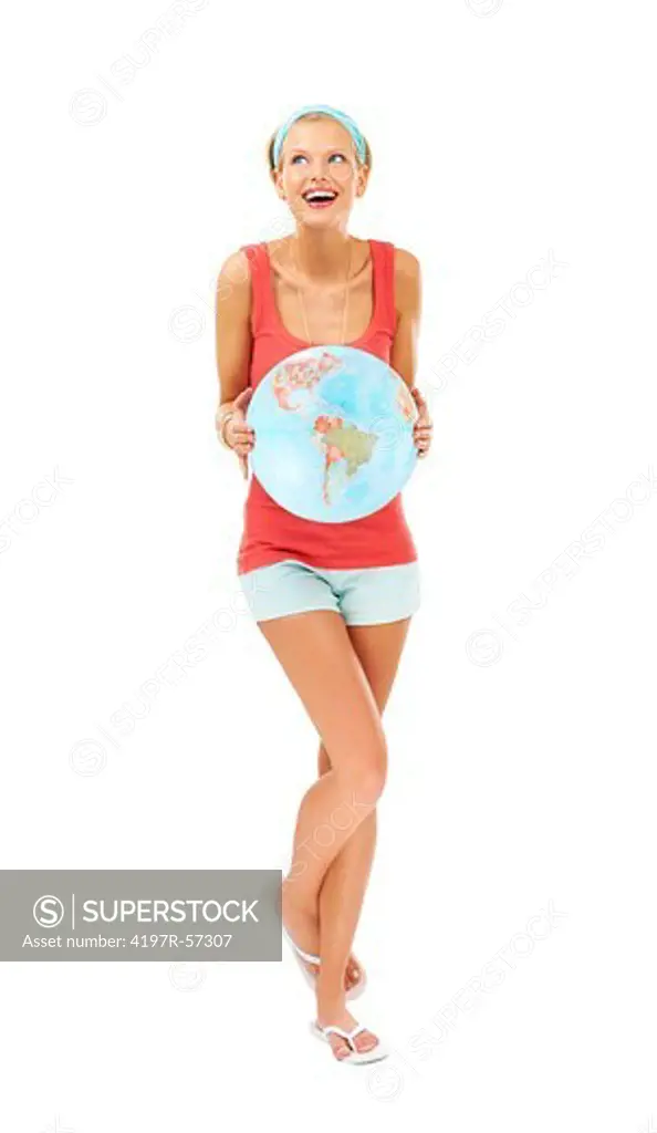 Casually dressed young woman laughing while holding an inflatable globe