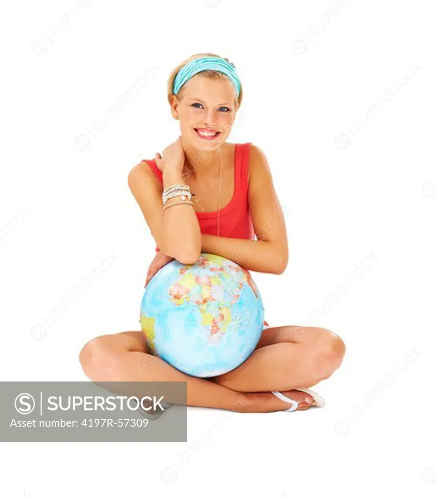 Cute young woman sitting cross-legged with a globe of the world in her lap