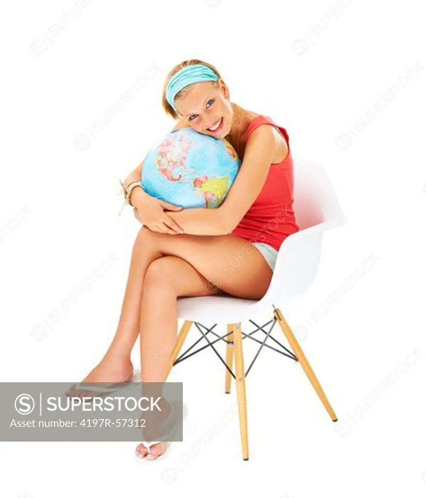 Smiling young woman holding tightly onto a globe of the world