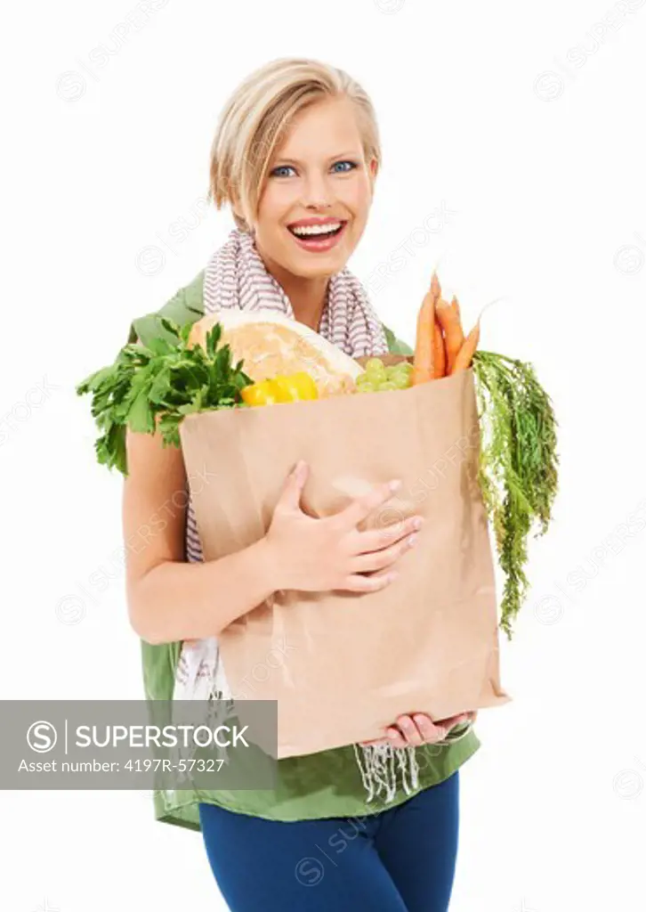 Gorgeous young woman holding a paper bag of healthy groceries
