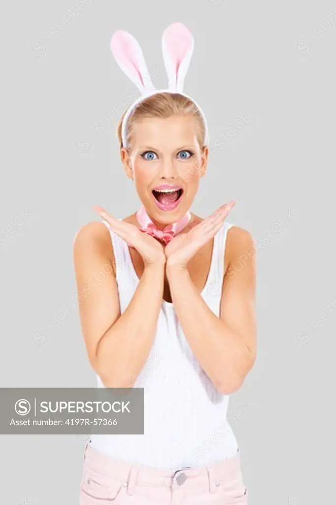 Surprised young woman wearing bunny ears - isolated