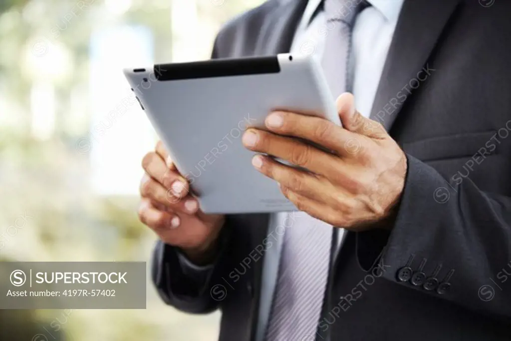 Cropped image of a businessman holding a digital tablet