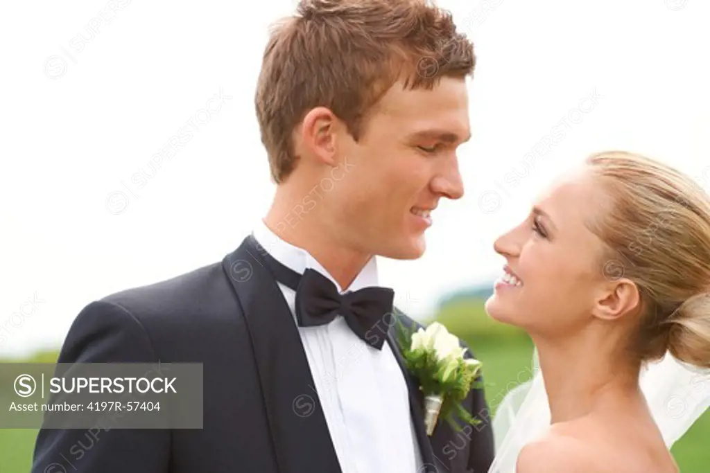 A newly married bride and groom stare lovingly into each other's eyes