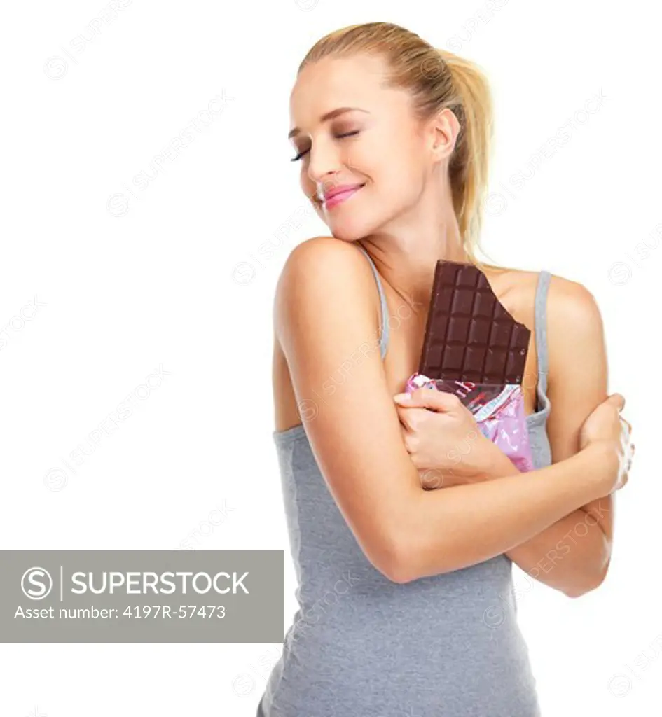 Smiling young woman holding a slab of chocolate close to her chest