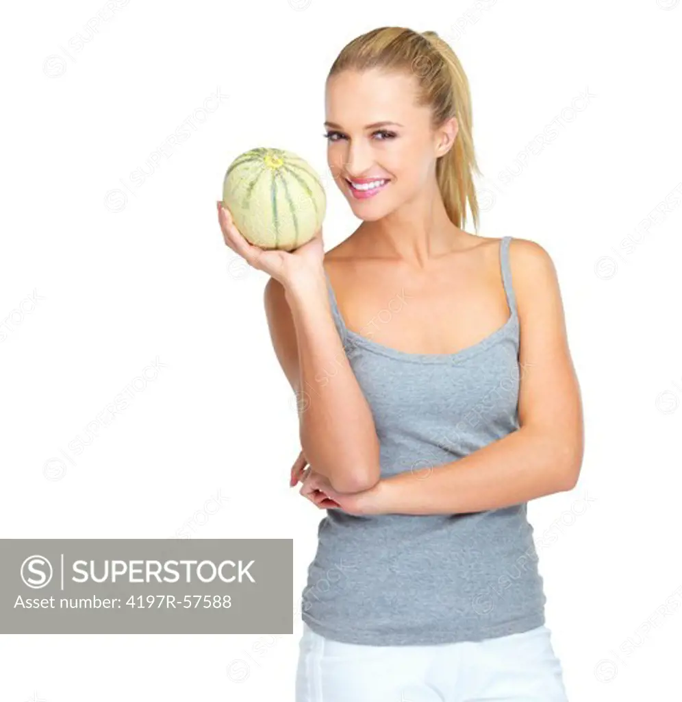 Young woman holding up a cantaloupe with a smile