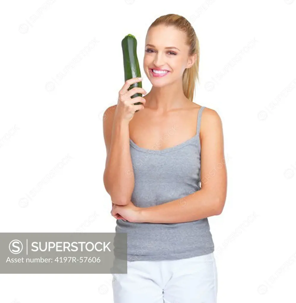 Pretty young woman holding up a marrow with a smile