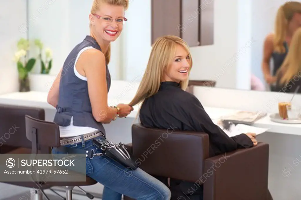 Young woman smiling while having a consultation with her hair stylist