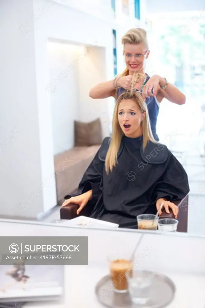 Shocked and dismayed young woman having a bad hair day at the salon
