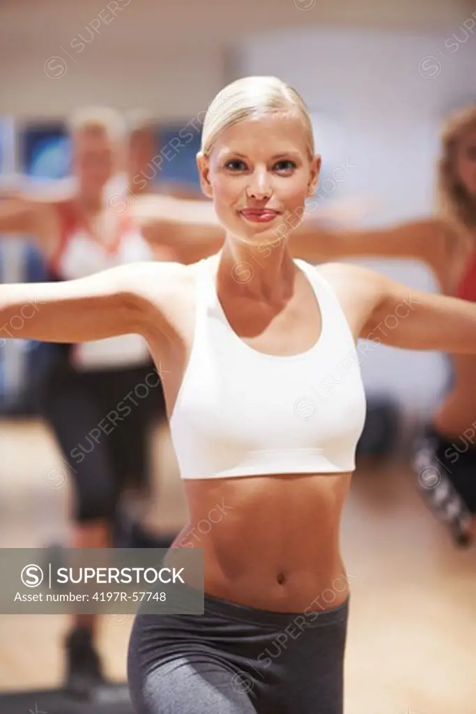 Portrait of an attractive young woman teaching an aerobics class