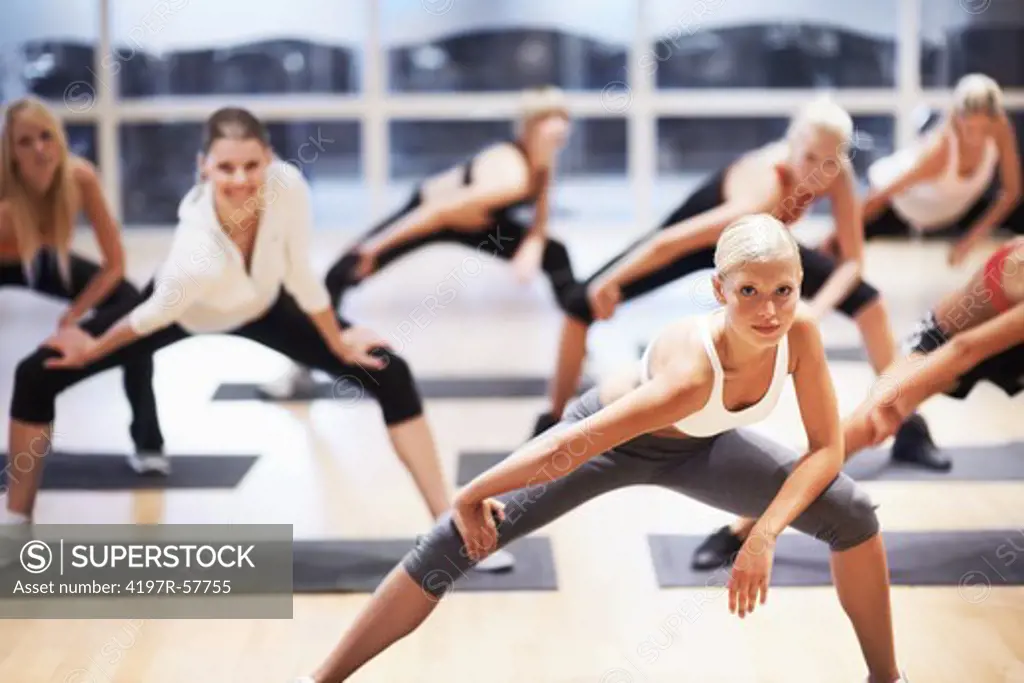 Portrait of a beautiful young woman leading an aerobics class