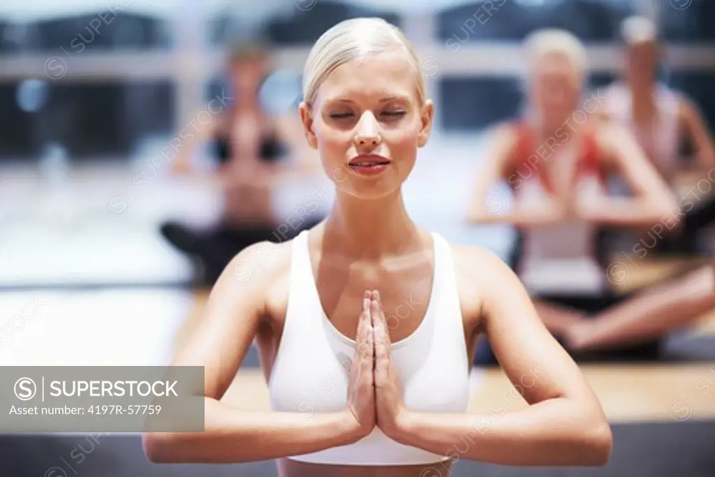 A beautiful young woman teaching a yoga class