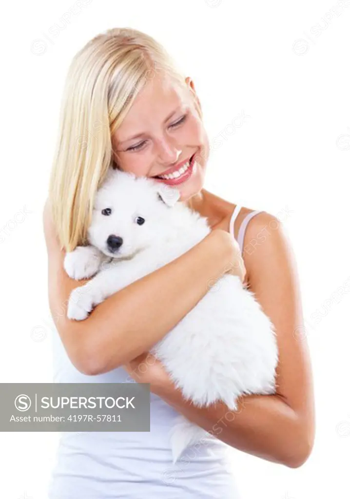 Pretty young woman hugging and cuddling an adorable Samoyed puppy