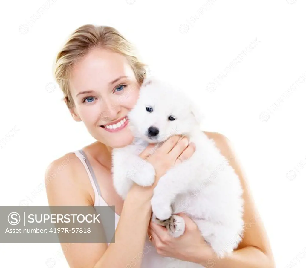 Attractive blond woman cuddling a fluffy Samoyed puppy