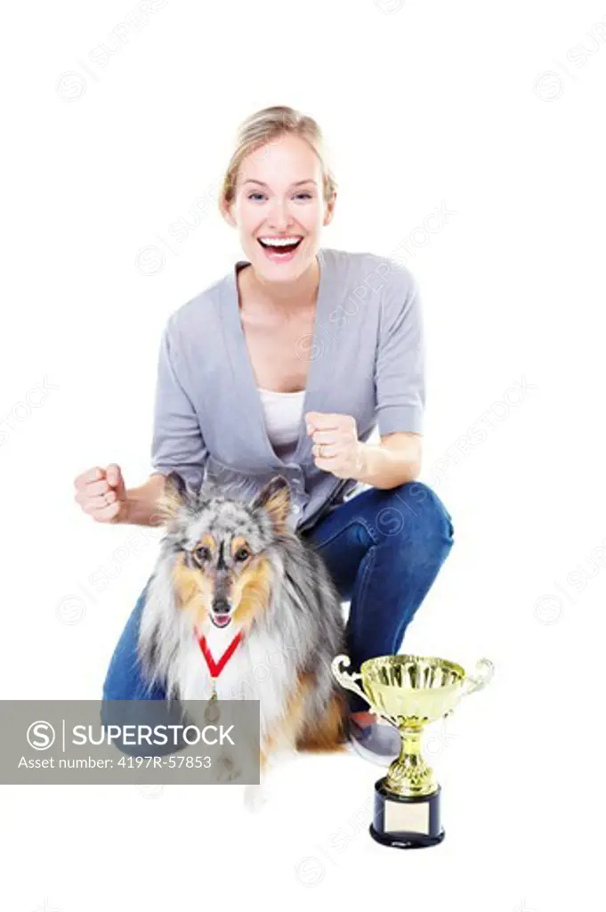 Beautiful young dog owner with her champion shetland sheepdog and a gold trophy