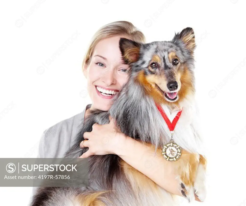Gorgeous young dog owner holding her champion shetland sheepdog