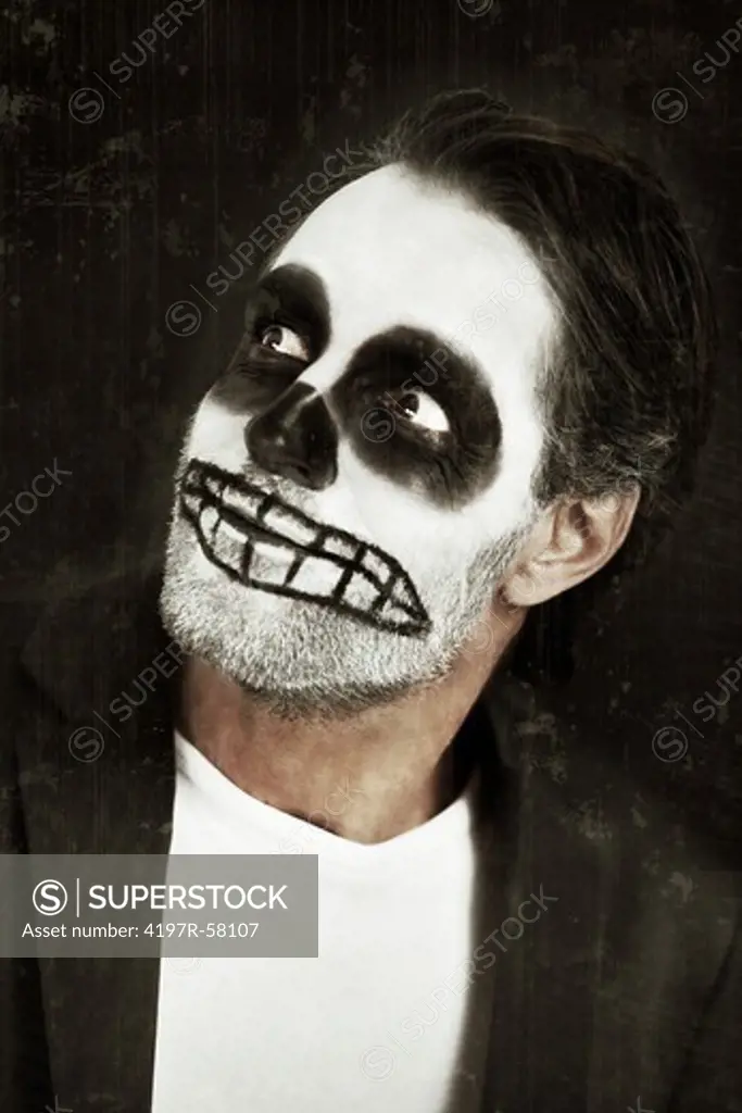 A man with his face painted like a skull on a white background