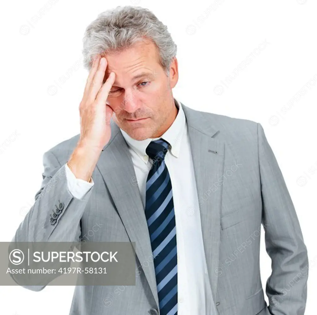An exhausted executive rubbing his head while isolated on a white background