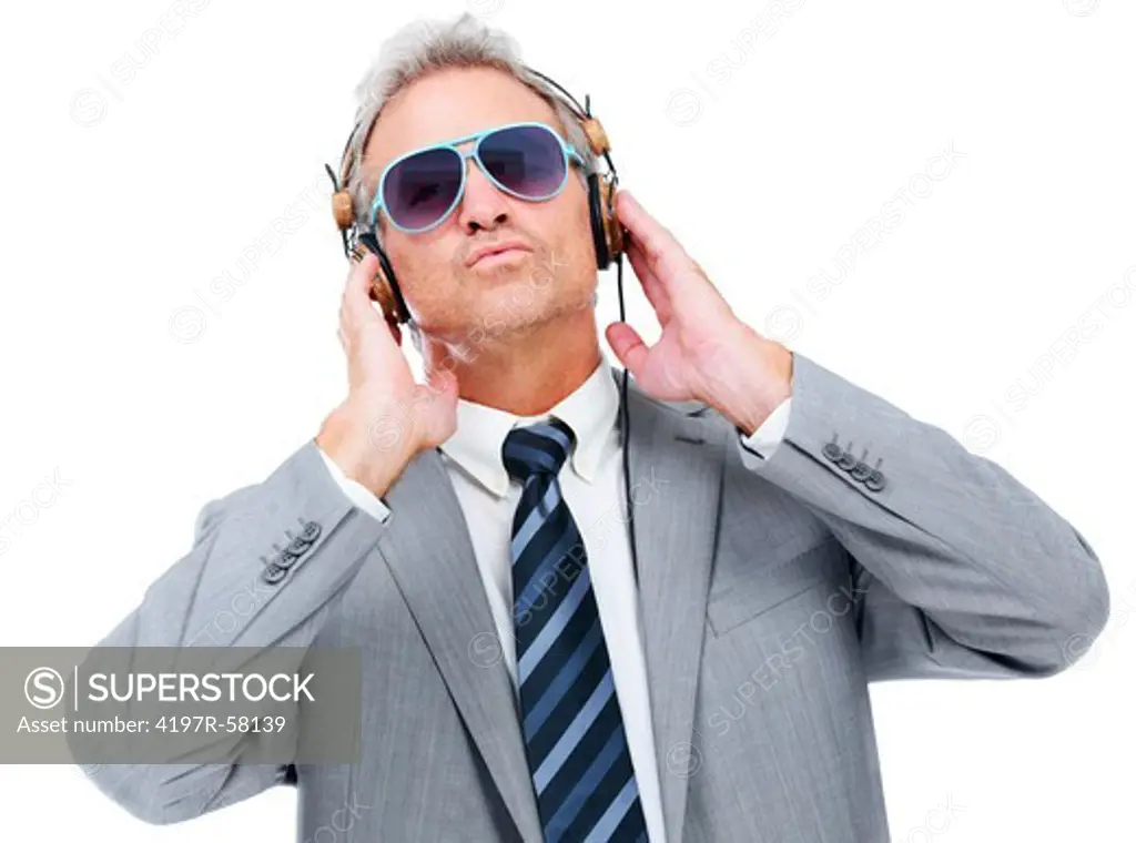 A young-at-heart executive wearing glasses and enjoying music on his headphones