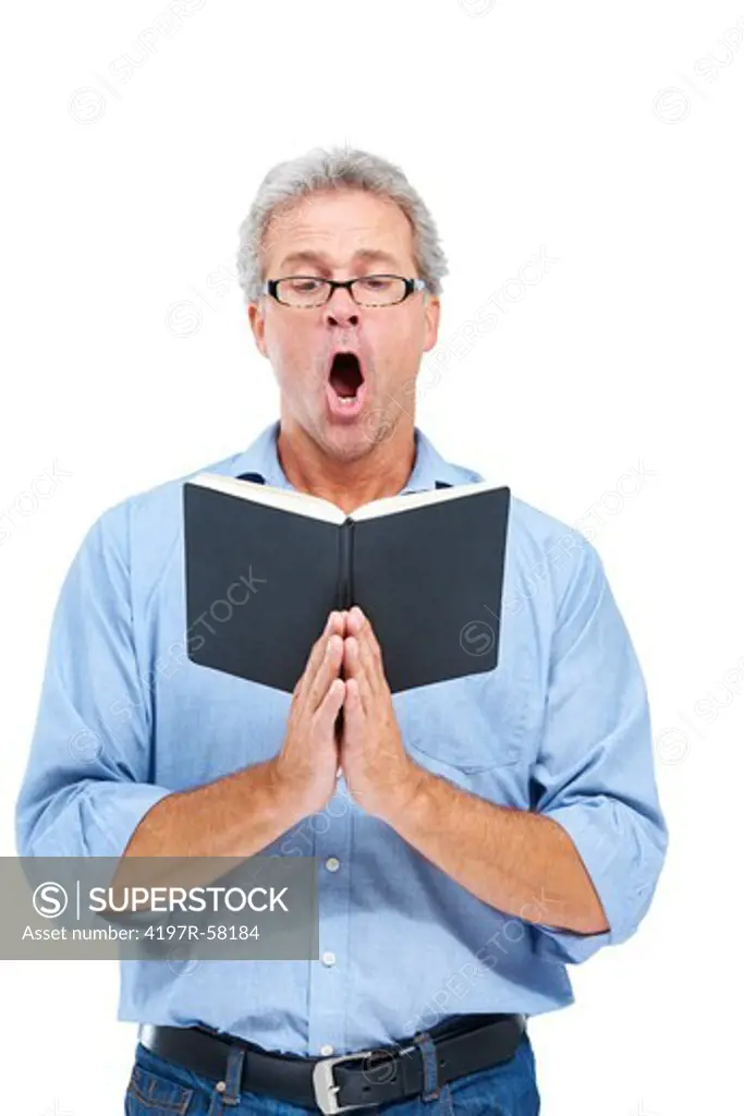 An avid mature parishioner singing from his book of hymns while isolated on white